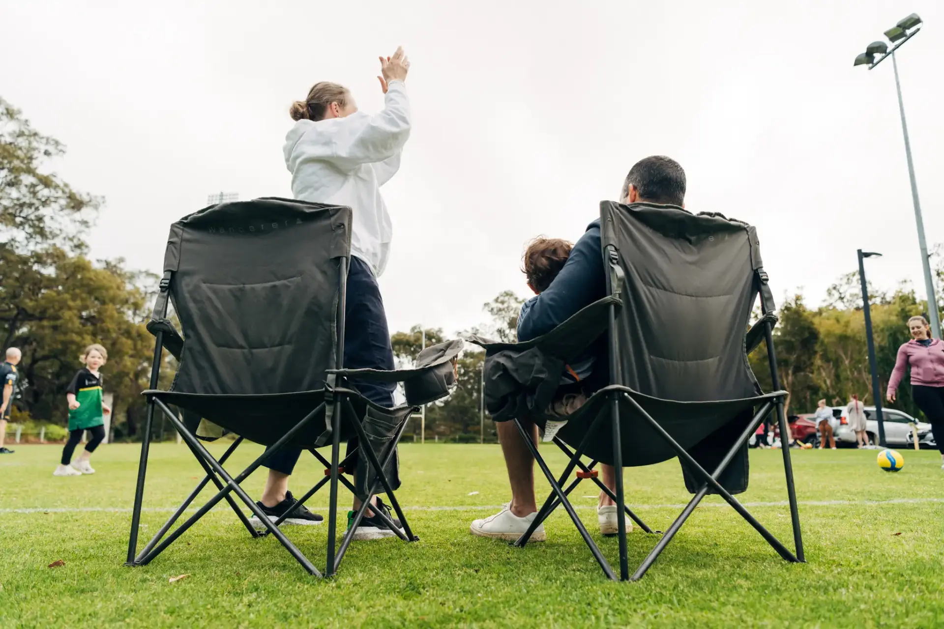 Spectators cheering from sideline